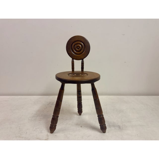 A sculptural French side chair in solid oak, in the manner of Charles Dudouyt, dating to the mid-20th century. The design...