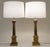 A bold and impressive matched pair of vintage Neoclassical Modern Brass stylized Corinthian Column table lamps designed by...