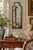 A distinctive Italian capriccio landscape, painted in oil on a shaped panel and presented in a softly worn giltwood frame....