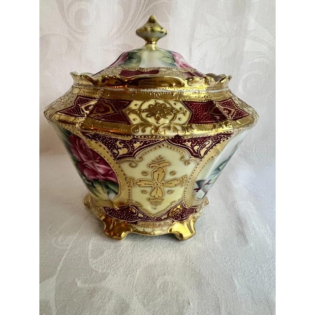A charming antique Nippon Morimura porcelain biscuit jar, dating to the late 19th or early 20th century, featuring an...