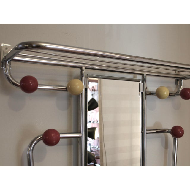This coat stand was made and manufactured in France in the 1940/50s. It is made from chromed steel with six red and yellow...