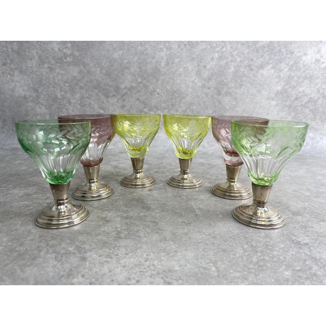 This elegant antique liqueur glasses features a beautifully cut glass bowl set on a finely crafted silver stem with...