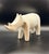A sculptural matte white rhino with a clean, modern silhouette an understated yet striking decorative object designed to...