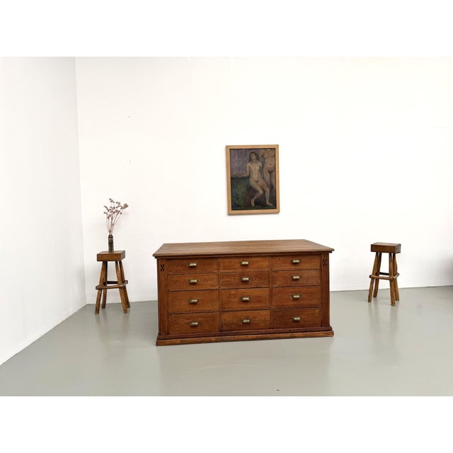 Large antique shop counter from the early 20th century, remarkable for its double-sided design. Made of solid oak and oak...