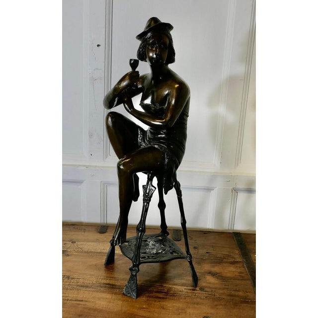 Bronze Statue of a Girl on a Stool Drinking Champaign This is a piece very much in the 1920s style, we have a slightly...