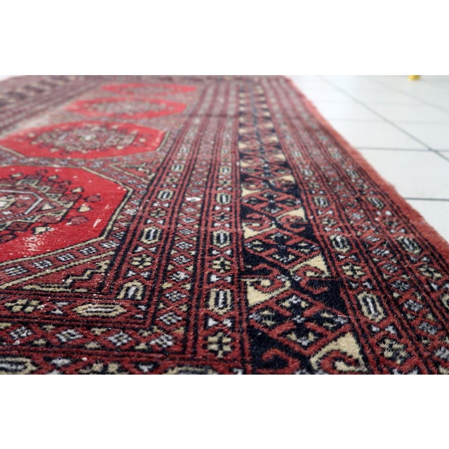 Antique Uzbek Bukhara Rug – Distressed 1930s Wool Piece 3' x 5.3' A handmade antique Uzbek Bukhara rug from the 1930s,...