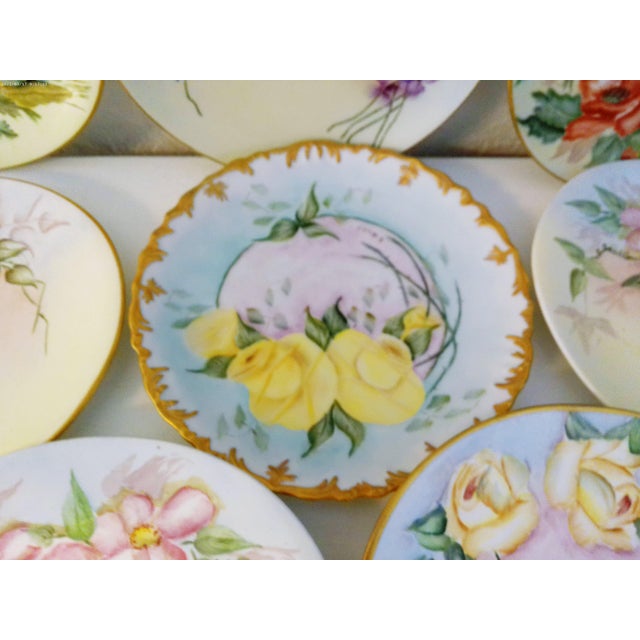 Lovely set of eight nicely matched vintage hand-painted porcelain plates each in a pastel shaded floral motif with gold...