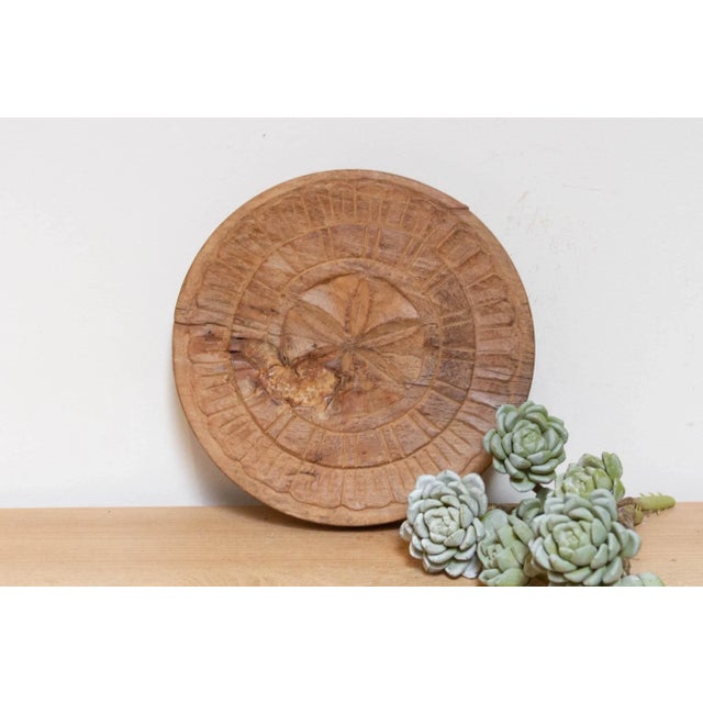 This finely carved vintage chapati plate, handcrafted from wood, brings a touch of global charm to your home. Originally...