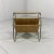 Beautiful magazine rack. Brass frame with beigebrown vinyl compartments, rattan handle. 1960’s. In very good condition.