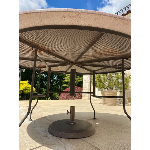 Beautiful granite table that is used outside. It has a hole in the middle for an umbrella. It's sturdy. This granite table...