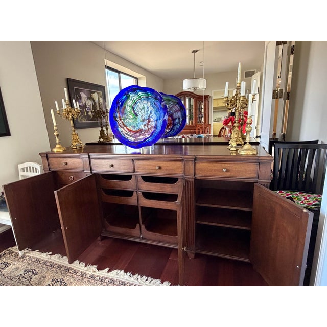 Custom 92-inch solid walnut sideboard made by Master Cabinetmaker. The piece was finished in 2020, installed as stage...