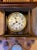 Antique Victorian era wall clock in decorative wood case with pendulum