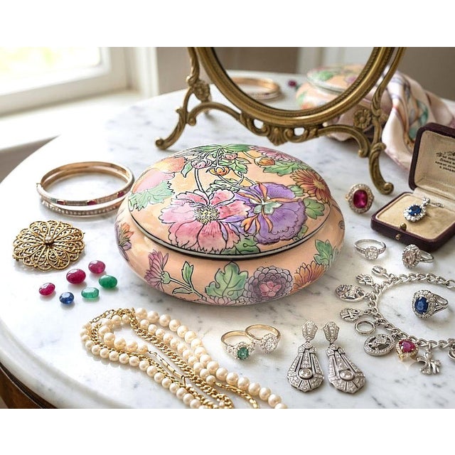 Offering a vintage Chinese Famille Rose porcelain lidded box, Mid 20th Century. This beautiful trinket or jewelry box is...