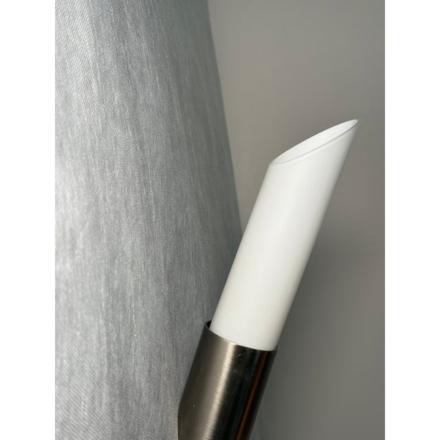 Elegant pair of slender Hillebrand wall sconces with a minimalist cylindrical form. The white rounded shades extend from...