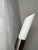 Elegant pair of slender Hillebrand wall sconces with a minimalist cylindrical form. The white rounded shades extend from...