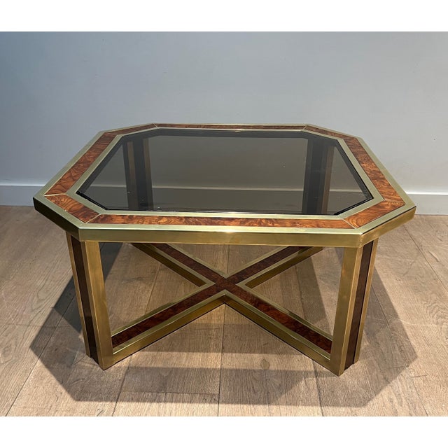 This beautiful octagonal coffee table is made of burr walnut and brass. It is a French piece. Circa 1970