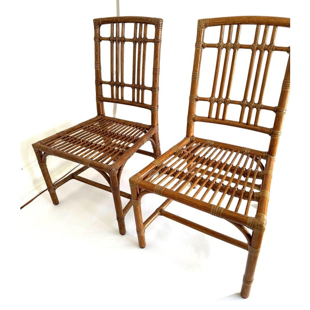 The McGuire Balboa Side Chairs are a set of two indoor dining chairs made with a rattan frame and finished in a pecan...