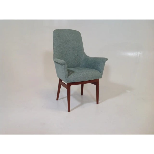 A Modern, mid century style dining chair. The base is walnut and on excellent condition. The teal blue upholstery is newly...
