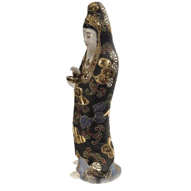 A refined Japanese Kutani porcelain figure of Kannon (Guanyin), Goddess of Mercy, dating to circa 1920. Standing in an...