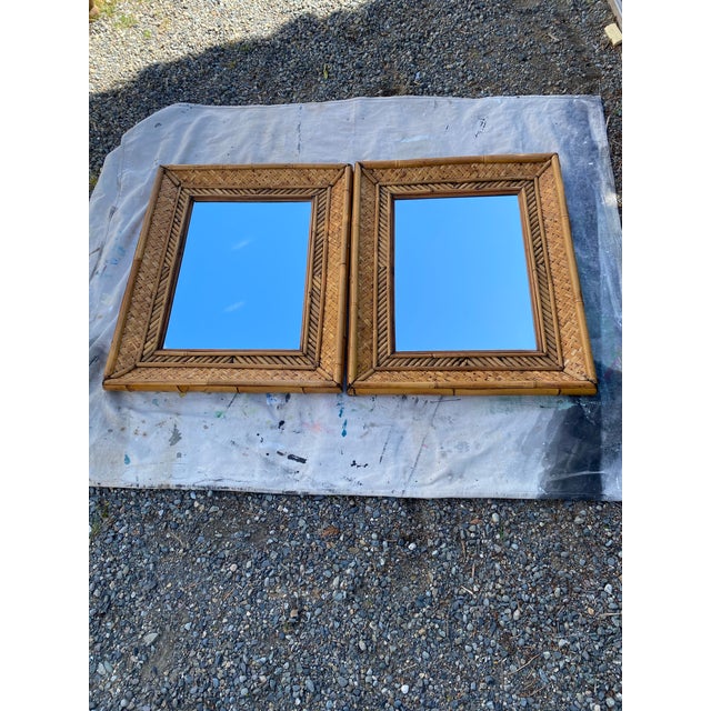A beautifully crafted pair of vintage woven bamboo and rattan wall mirrors, showcasing the timeless appeal of natural...