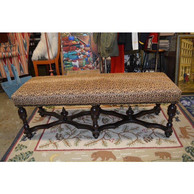This is a great looking bench / ottoman with a cheetah print cowhide top. Medium, soft seating. Nail head trim & a carved...