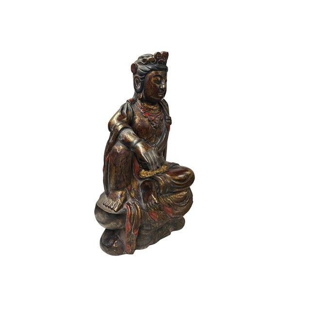 Discover the sublime serenity of this hand-carved Antique Chinese Gilt Wood Guanyin Bodhisattva Statue, captured in the...