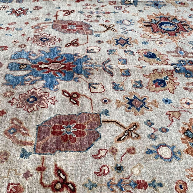 Persian Ziegler design hand-knotted rug featuring a luminous ivory field with a gracefully scattered all-over composition...