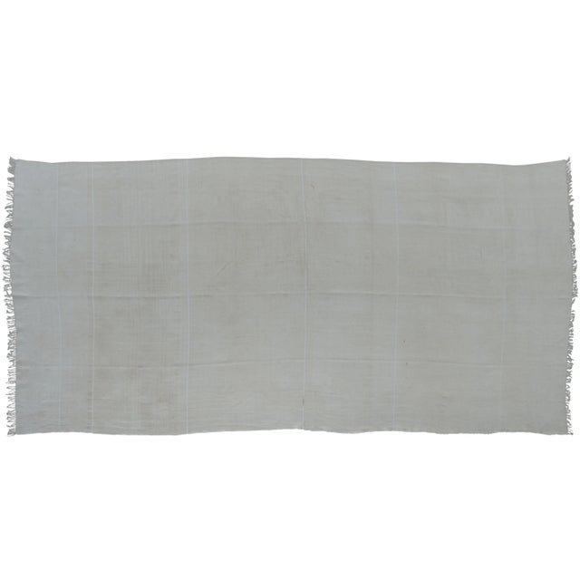 Vintage throw handmade in the High Atlas Mountains of Morocco. Featuring ornate Berber stripes on a beige background....