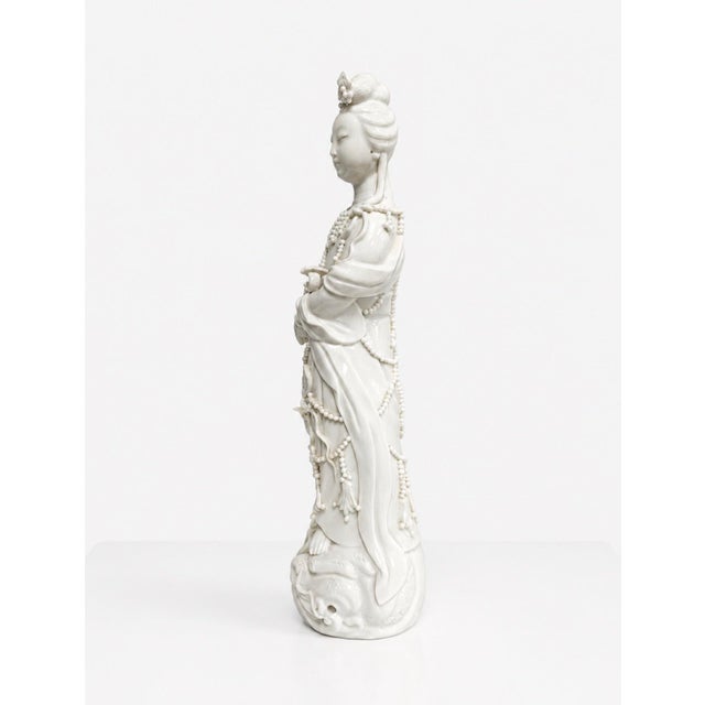 A beautiful antique Blanc de Chine porcelain Guanyin figure, likely dating to the late 19th or early 20th century. She has...