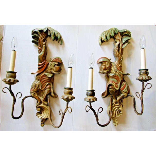Pair of antique polychrome hand-carved wood and iron monkey wall sconces from the early 20th century. The multicolor...