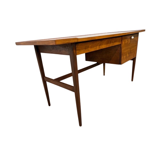 A beautifully refinished Mid-Century Modern Drexel Declaration walnut writing desk, showcasing the clean lines and refined...