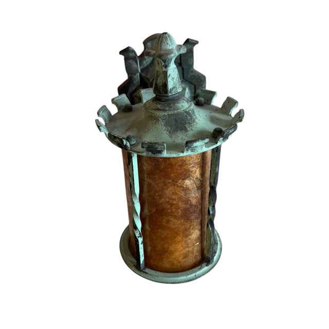 This is an antique 1920s Arts and Crafts / Art Nouveau cast brass and mica lantern wall sconce finished in its original...