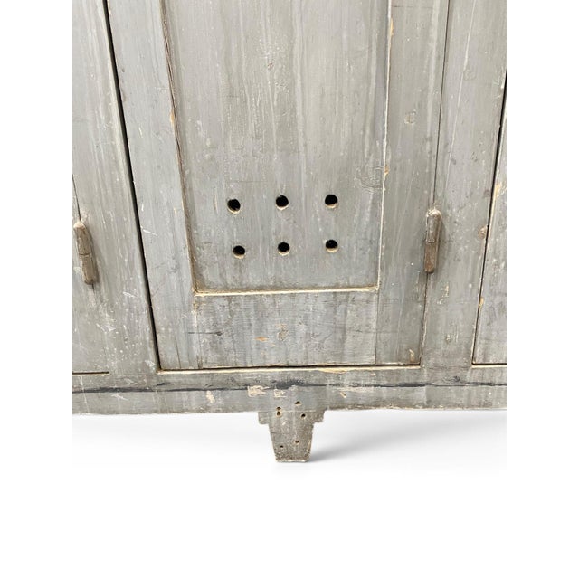 A vintage French factory wooden changing room cabinet with five doors, original hardware in a blue grey patina. Each door...