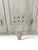 A vintage French factory wooden changing room cabinet with five doors, original hardware in a blue grey patina. Each door...