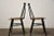 A pair of mid century modern teak dining chairs. Unmarked. Possibly by Ilmari Tapiovaara. Seat height is 17.5”. 16.75”...