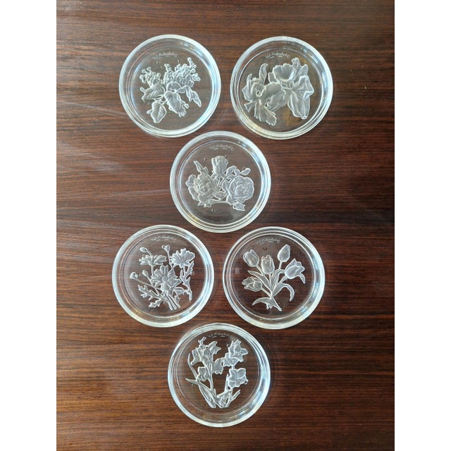 Set of 6 Val Saint Lambert crystal coasters with original box. Each coaster is finely engraved with floral motifs. The set...