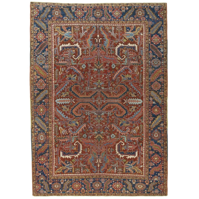 This expressive antique Heriz rug is hand-knotted and distinguished by its characteristic geometric pattern and rich, warm...