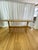 Harnett Wood Designs trestle dining table featuring solid wood construction and a warm natural finish. The table showcases...