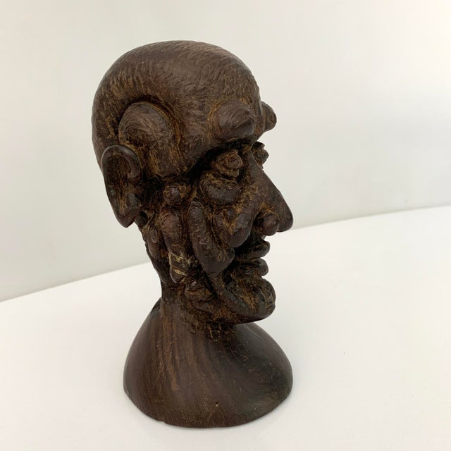 Vintage and Unusual Head sculpture in a heavy ironwood. Unsigned Size: 6" tall, 3.25" w, 4" d Condition: one area looks to...