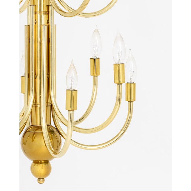 Mid-Century Modern Brass 16-Branch Chandelier, with two rows of eight branches. 42" H x 20" Diameter. Provenance: From a...
