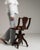 This piece presents as a swivel desk chair, distinguished by dark walnut, turned column base. Dating to 1900s and...