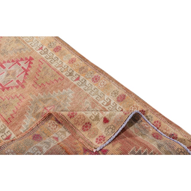 Beautiful Anatolian Turkish Runner rug, hand knotted with a coral field, ivory, tan and pink accents in all-over geometric...
