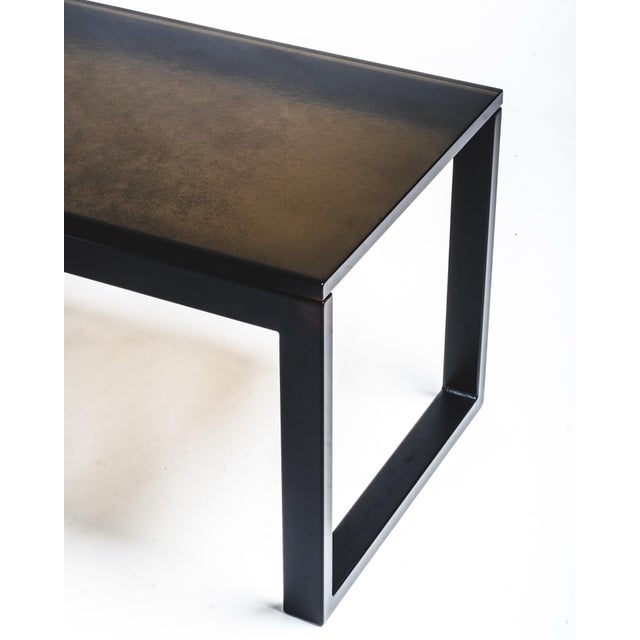 This custom handmade glass coffee table features a seamless, kiln cast 3/4″ thick bronze glass top. In low light, the...