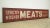 Reclaimed movie set sign made of aluminum in white, red, and black colors. The sign reads "Strictly Kosher Meats Finest...