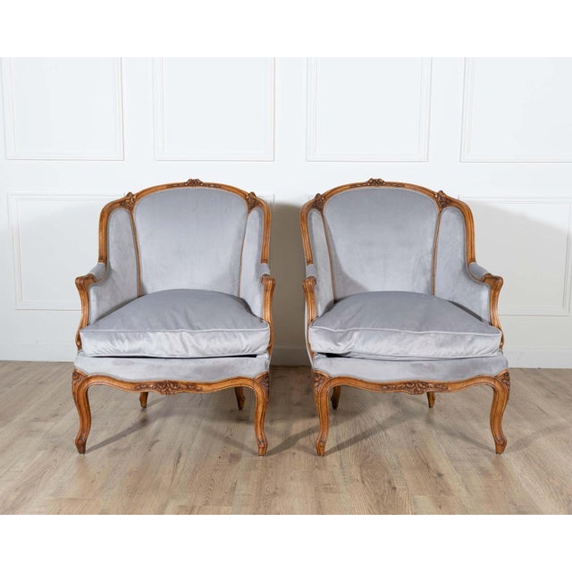 A graceful pair of Louis XV-style gondola armchairs from the 20th century, crafted in beechwood and newly upholstered for...