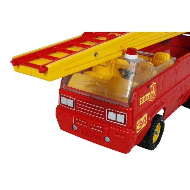 A 1970’s red fire truck by Tonka, model XR-101. Made of pressed steel body with plastic. On top is a ladder that extends...