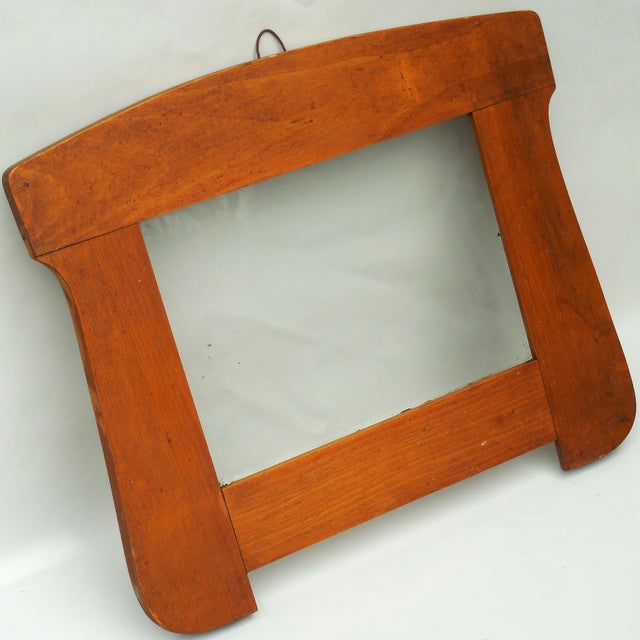 A striking example of Dutch Amsterdam School design, this solid oak mirror frame features the movement’s characteristic...