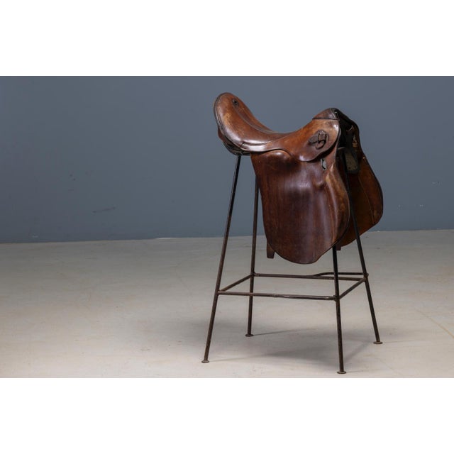 This distinctive pair of bar stools combines saddle-inspired leather seating with a minimalist metal structure. The design...