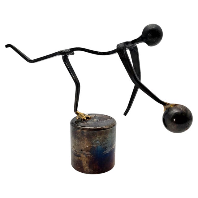 Constructed from welded nails, forged rods, and a heat-treated cylindrical metal base, this 1970s studio sculpture...