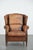 We present this charming sheepskin wing chair in warm colors, finished with decorative nails. This sheepskin wing chair is...